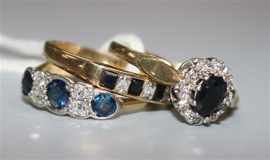 An 18ct gold, sapphire and diamond half hoop ring and two 9ct gold and gem set rings.